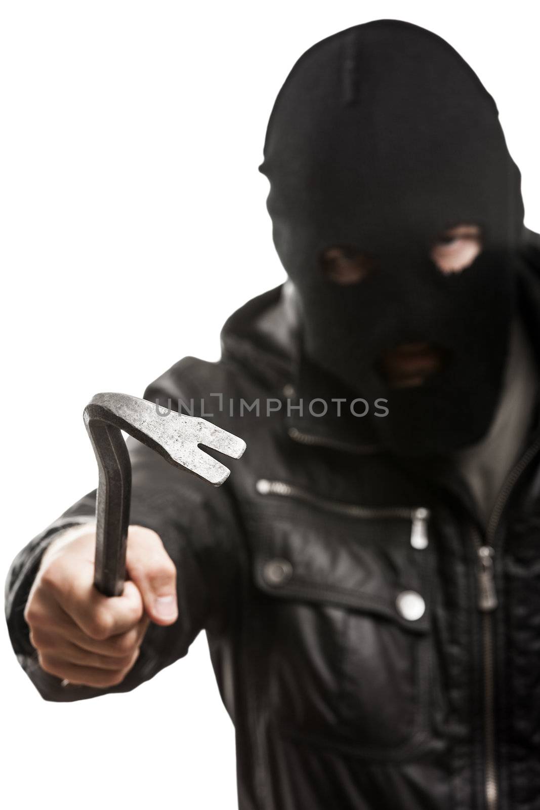 Crime scene - criminal thief or burglar man in balaclava or mask covering face holding crowbar in hand for break opening home door lock