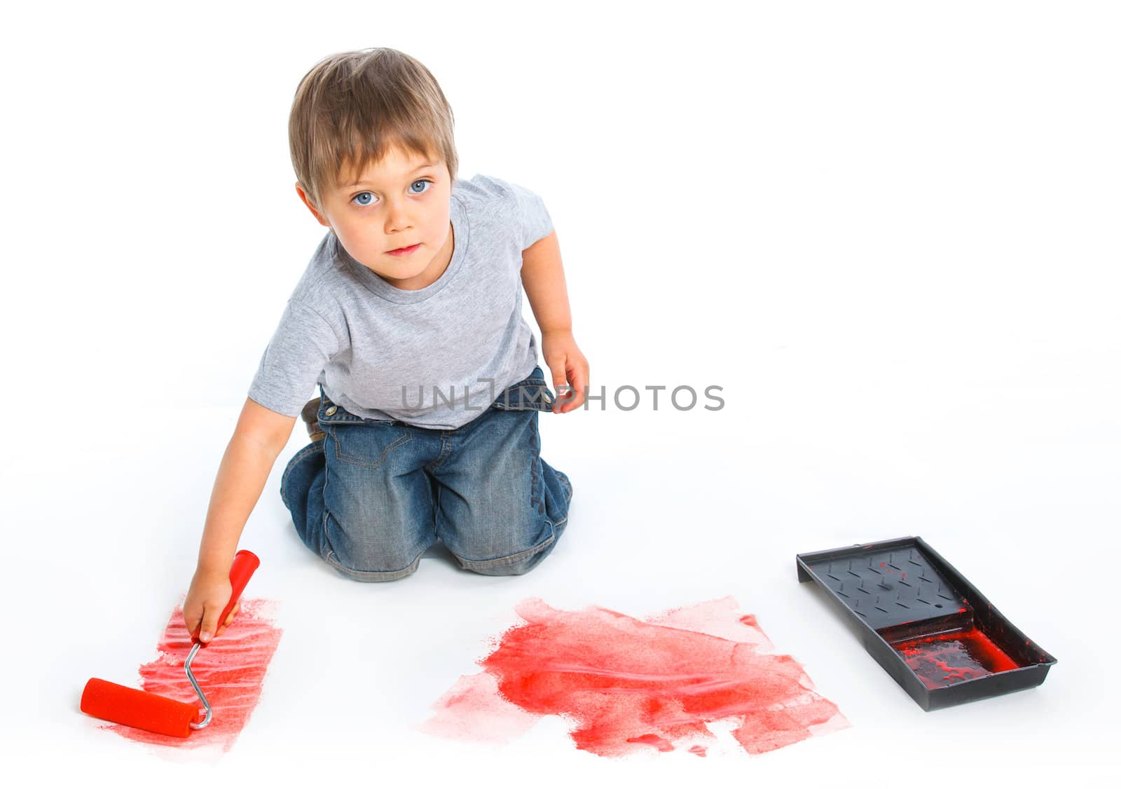 happy young boy painting. Vertical view. Isolated over white background.