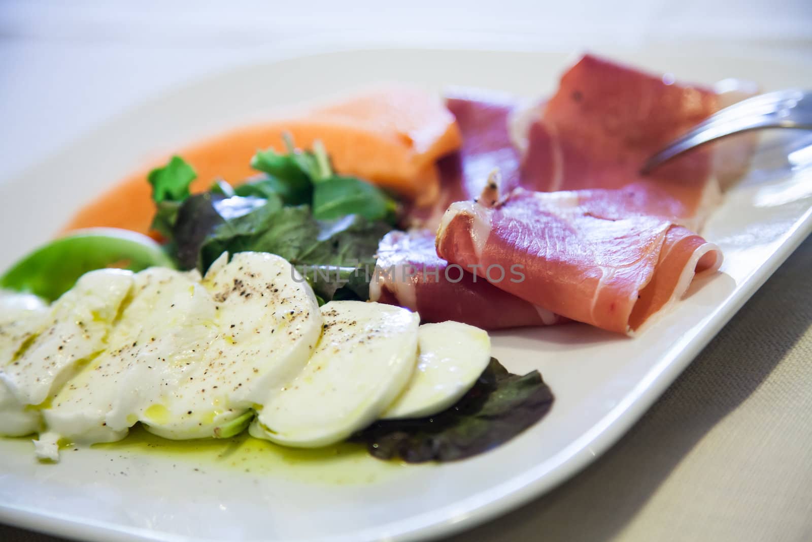 Italy, the best restaurant in Florence.  Ham, mozzarella and vegetables on the restaurant table.