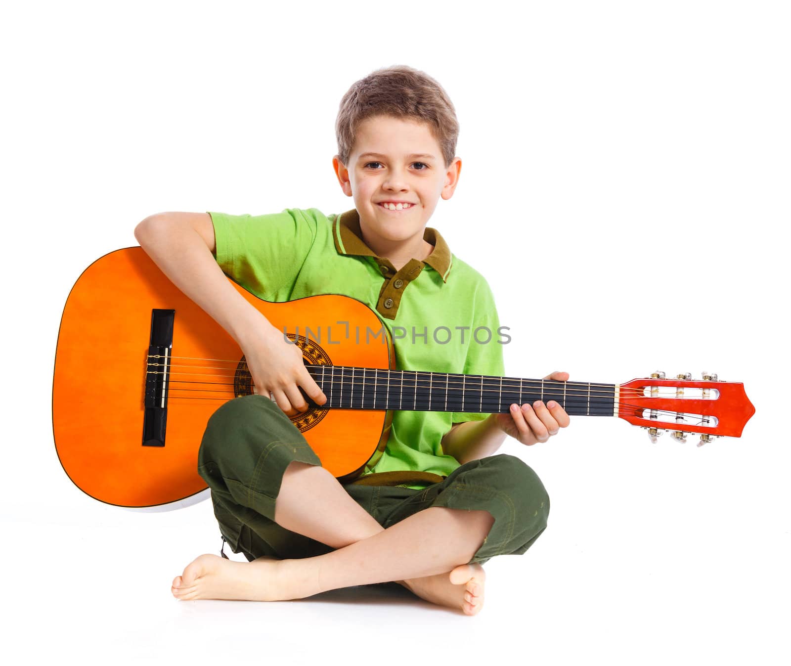 Cute boy with classical guitar. Isolated on white background