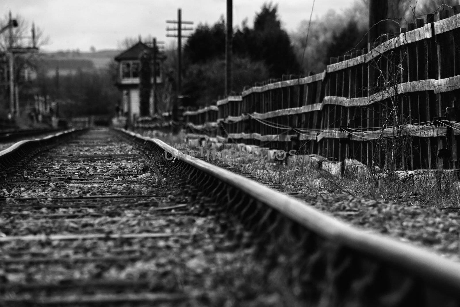 Black and white image of a set of derelict train tracks from the days of the steam locomotive