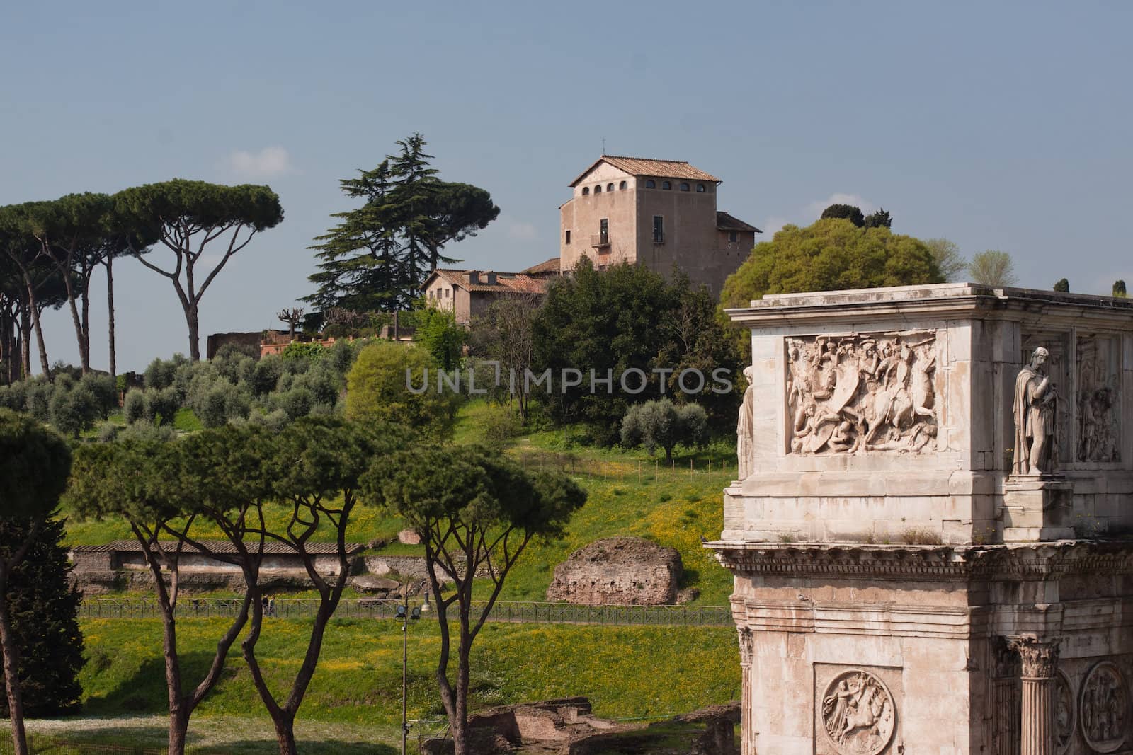 An old building on the hill and an triumphal arch in Rome
