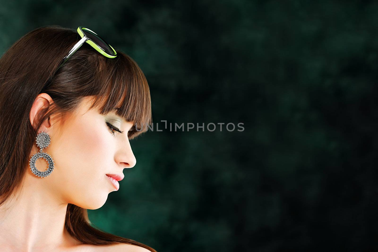 Pretty young woman on dark background