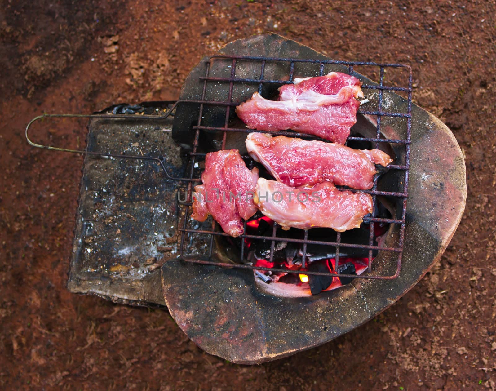 Traditional charcoal-grilled meat on the ground