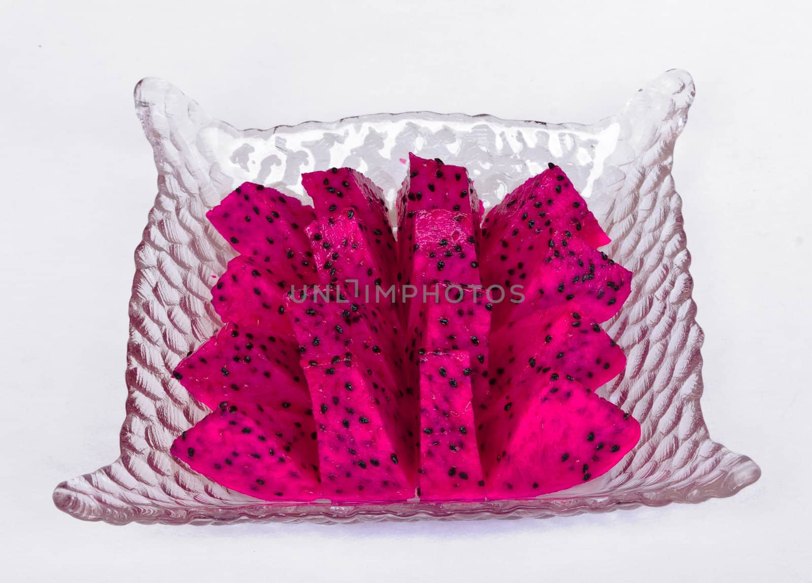 Red dragon fruit cut into pieces in a glass dish