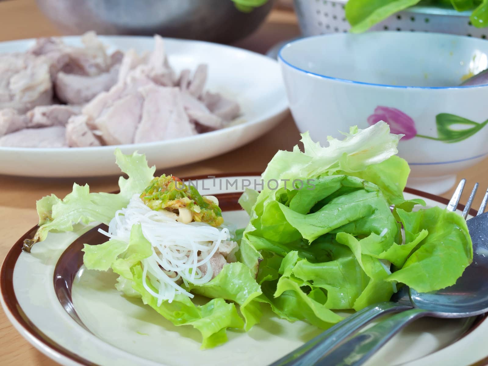 Thai style salad with leaf lettuce, noodle, slice boiling pork and spicy sauce