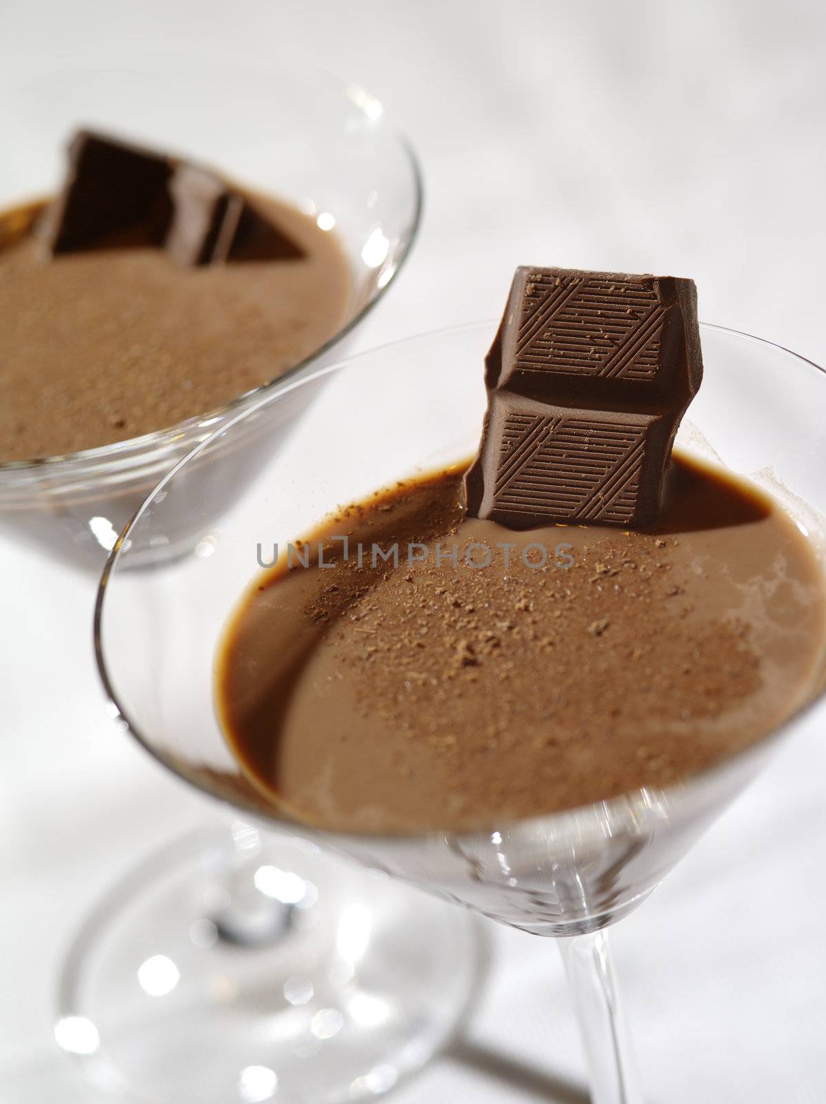 Photo of two chocolate martinis with a very shallow depth of field, focus on the chocolate garnish.