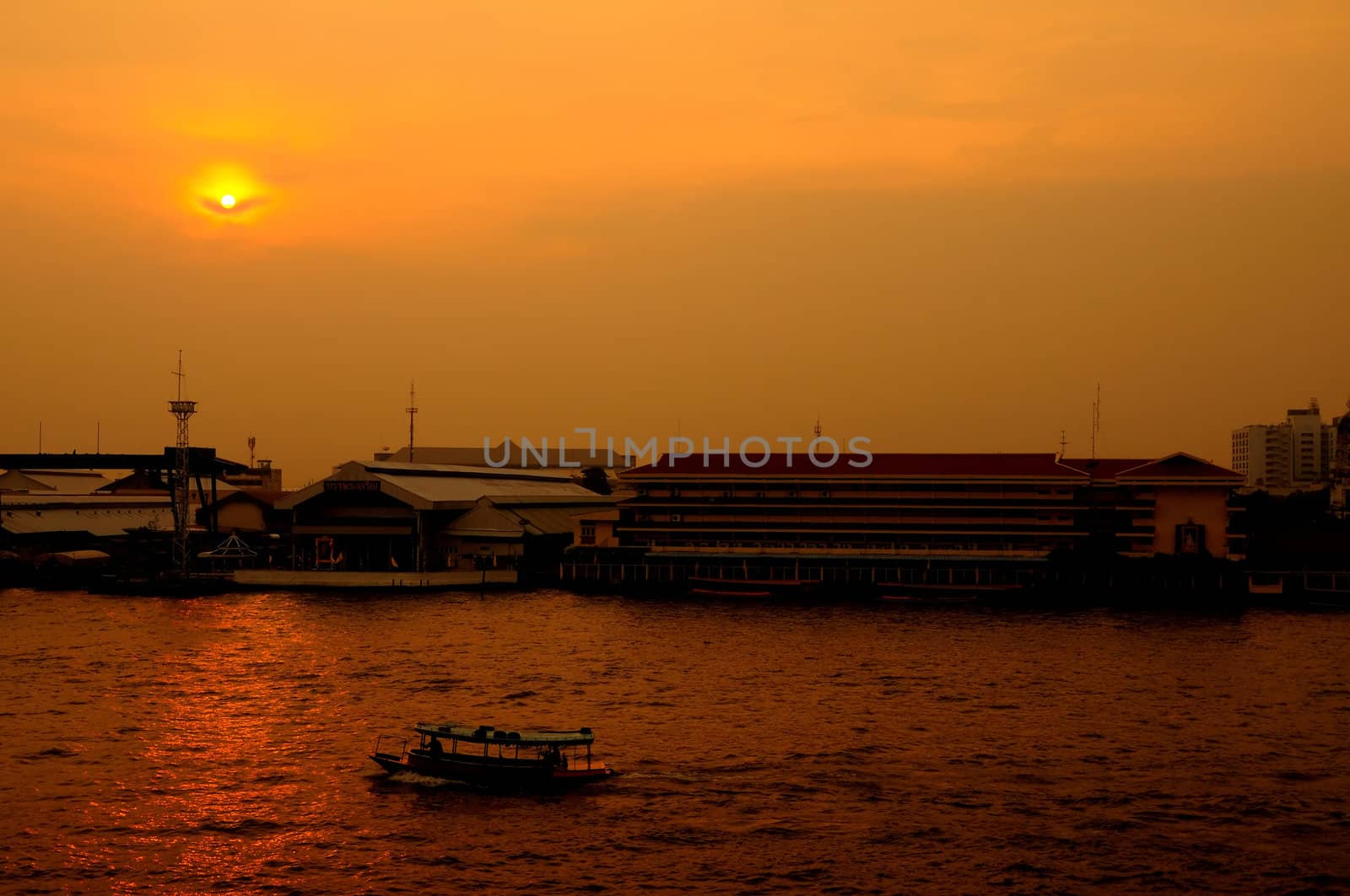 Long tail boat in Chaopraya river at sunset
