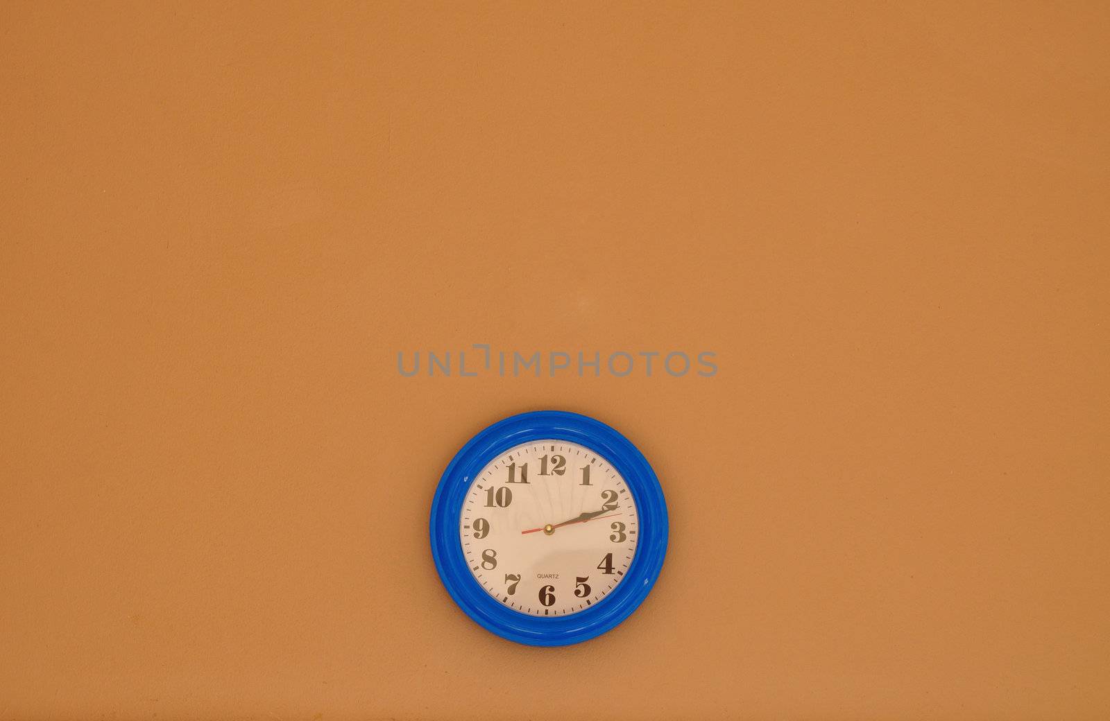 Blue and White Clock on brown Wall