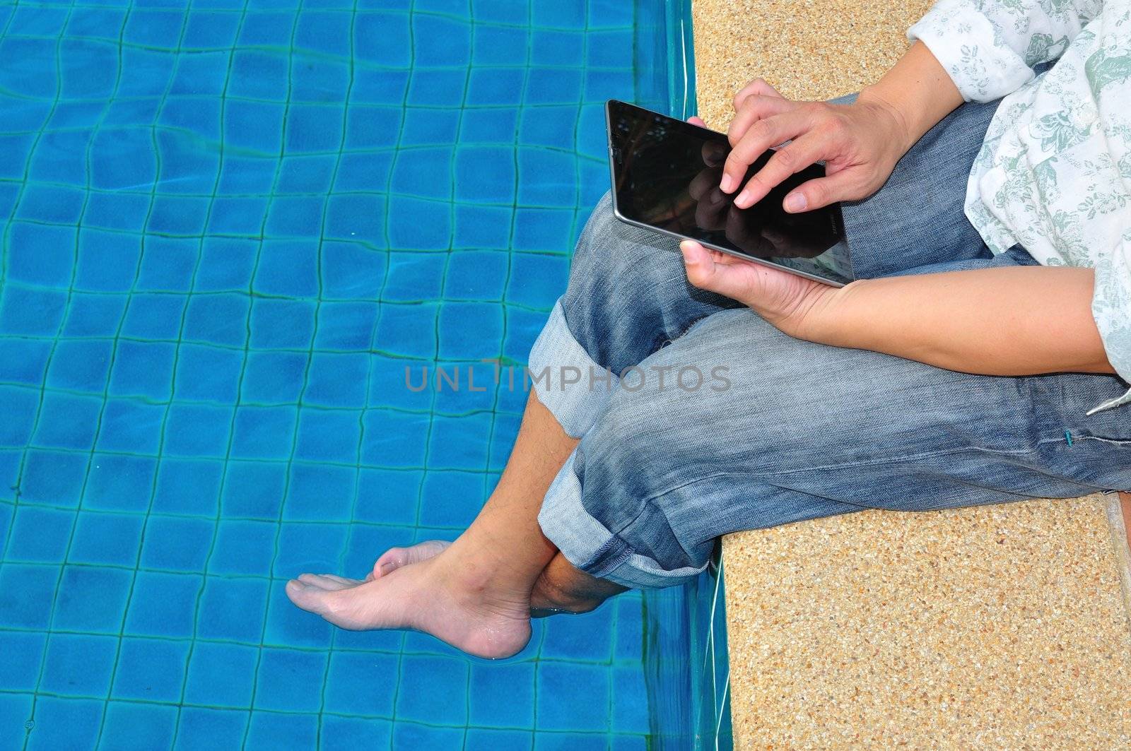 Business Man use laptop beside swimming pool as relaxation concept