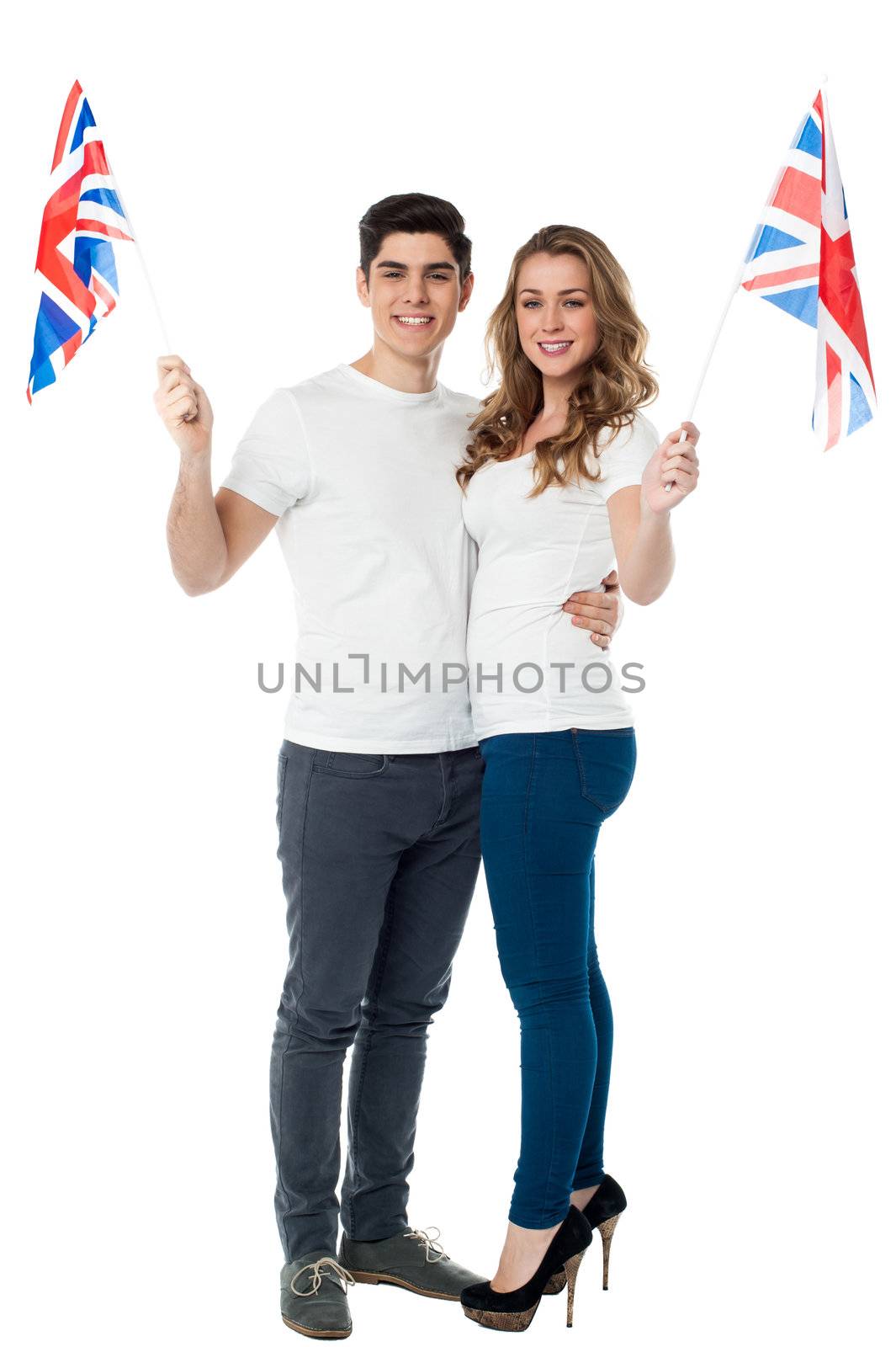 Cheerful couple waving the British flag by stockyimages