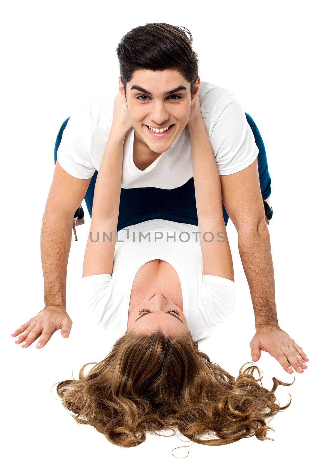 Charming young woman lying on the floor and clinging on to her partner.