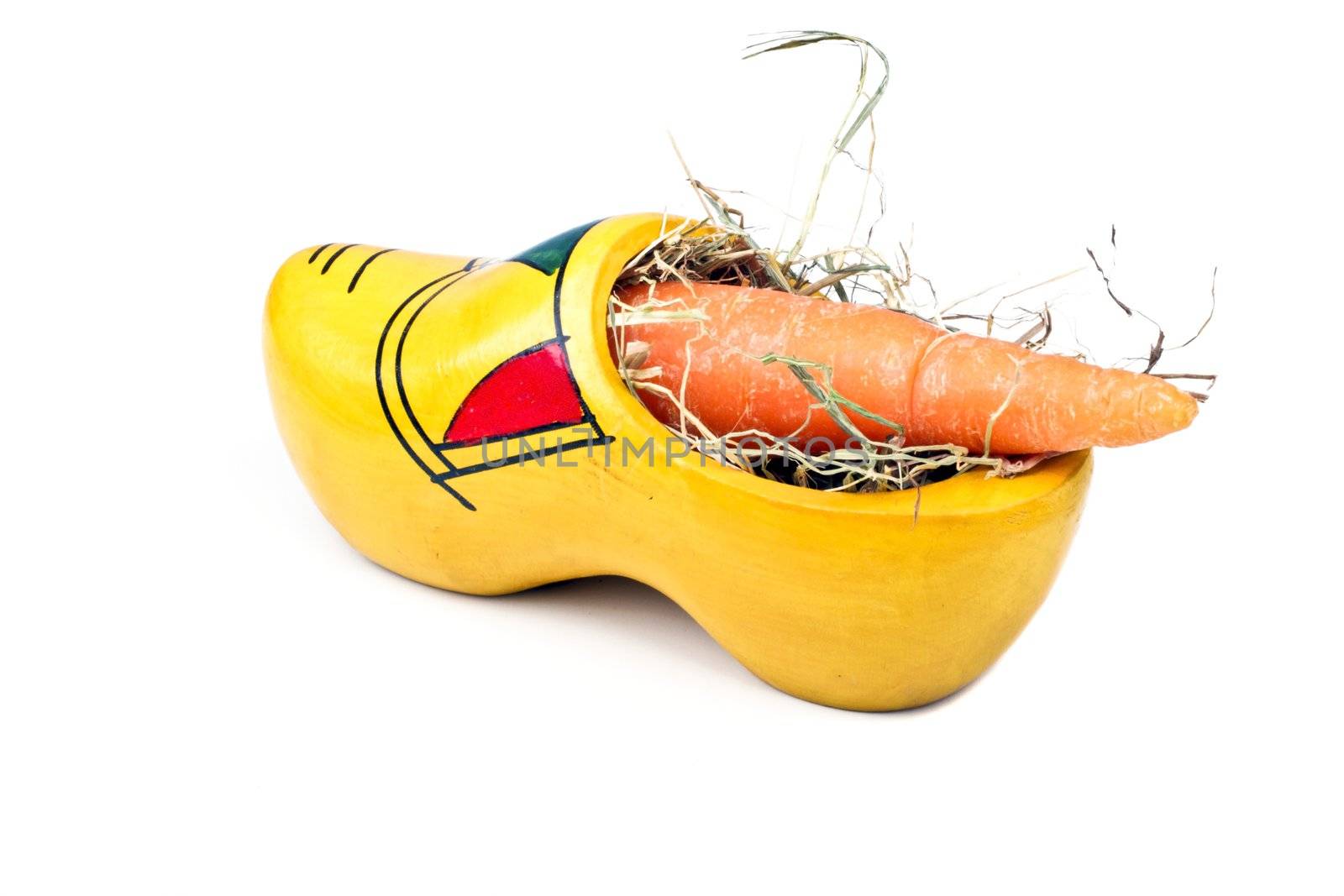 Traditional dutch clog with hay and a carrot