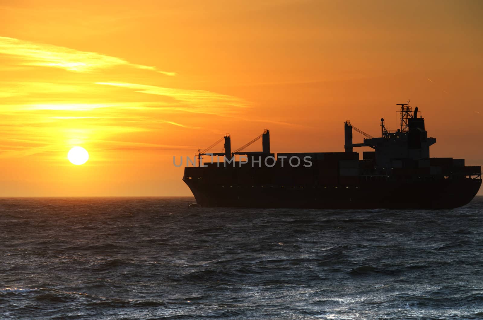 Container Ship cruising into the sunset on the North Sea.