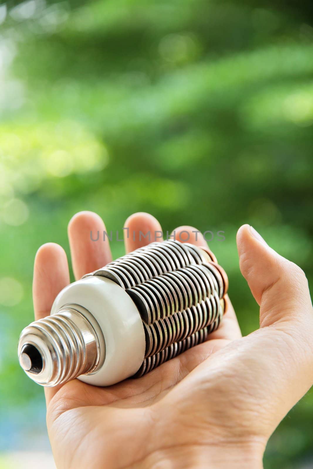 hand holding coin light bulb,energy concept by ponsulak