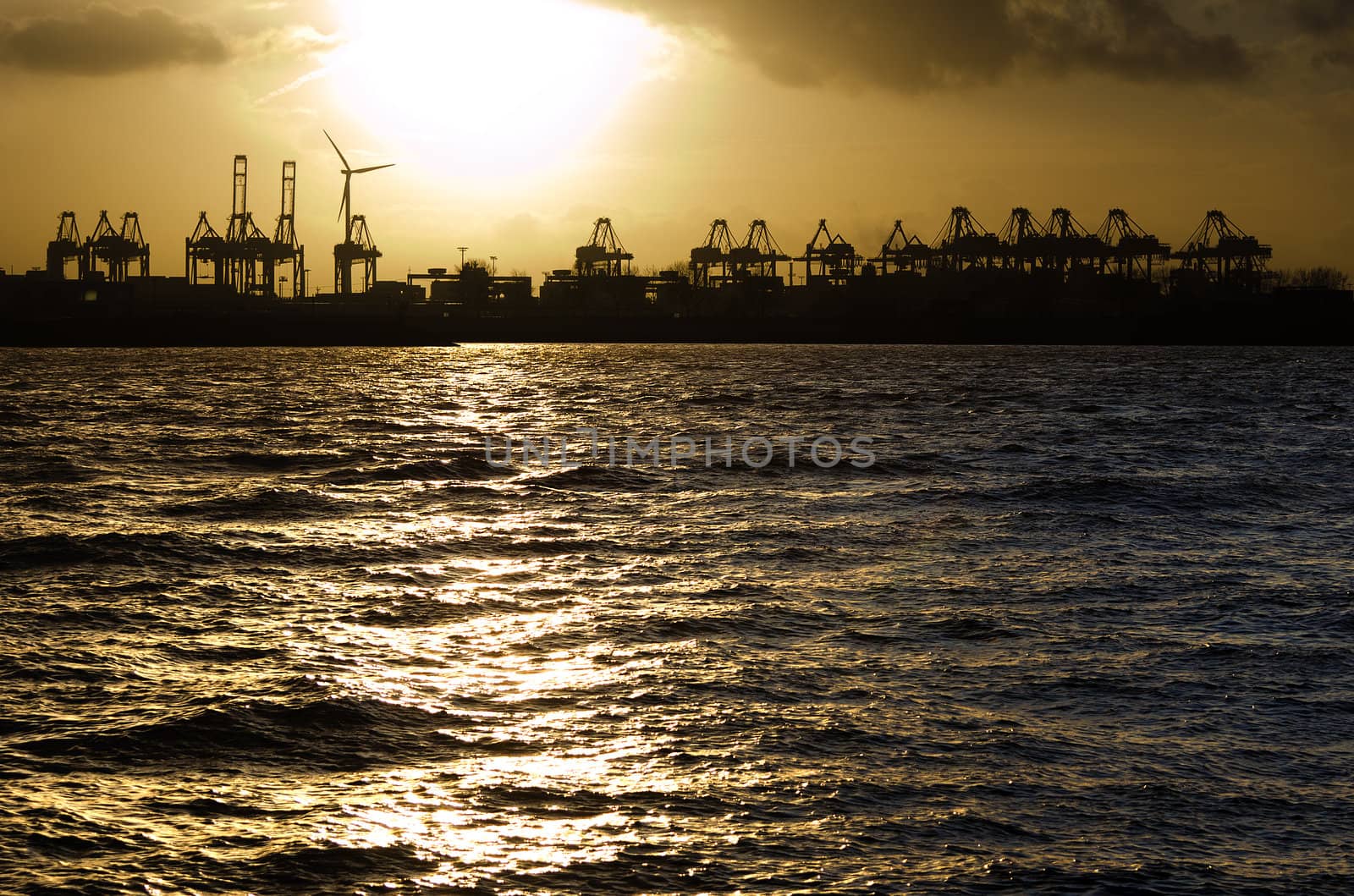 Sunset over the harbour of Hamburg, Germany.
