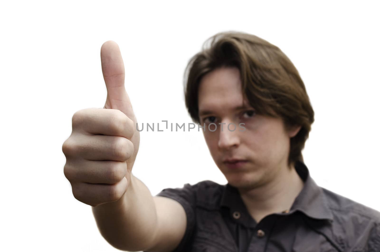 A young man showing thumps up sign. Isolated on a white background.