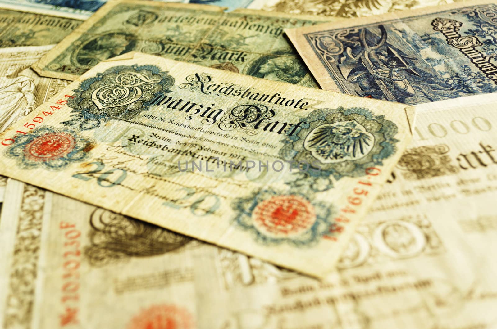 Old German banknote from 1914 lying on top of other old banknotes.