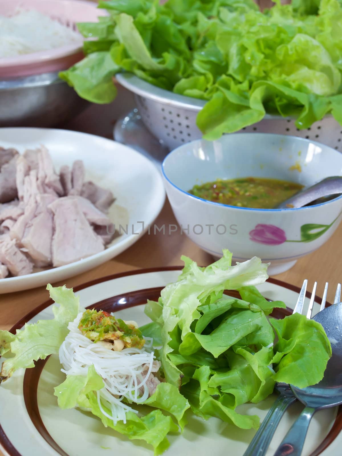 Thai style salad with leaf lettuce, noodle, slice boiling pork and spicy sauce