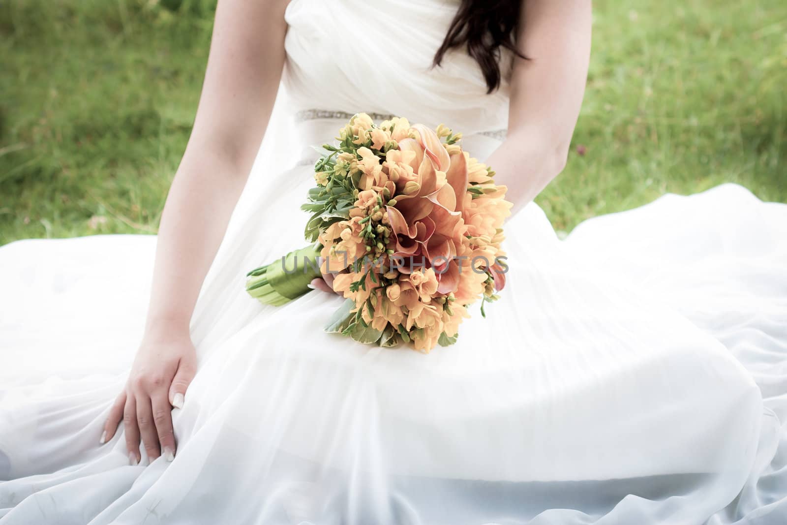 Bride holding a wedding bouquet by PixAchi