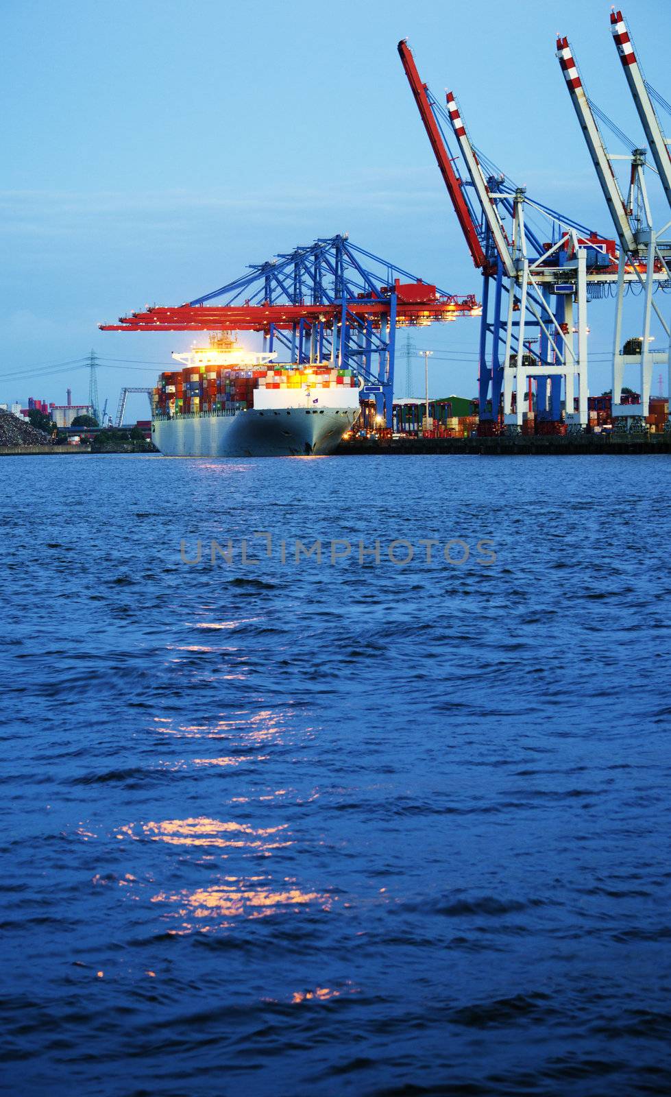 Image of container ship in the process of unloading in the harbor of Hamburg, Germany.