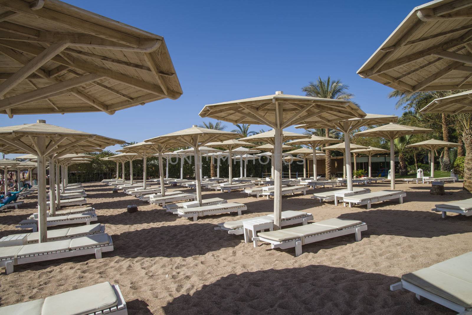 empty sun loungers on the beach in naama bay, sharm el sheikh, egypt, the image is shot in January 2013.