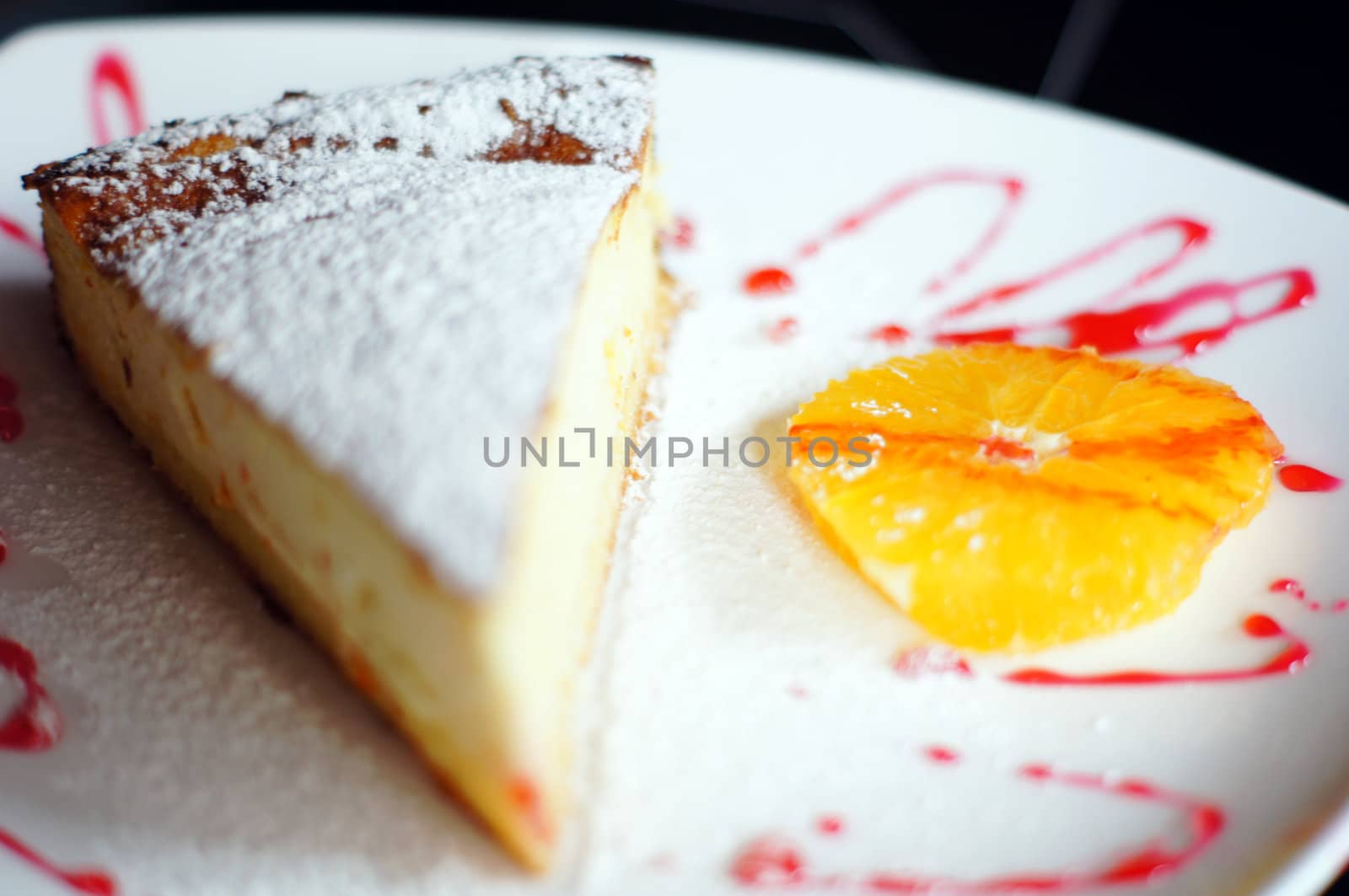 Close up of cheesecake and orange by Elet