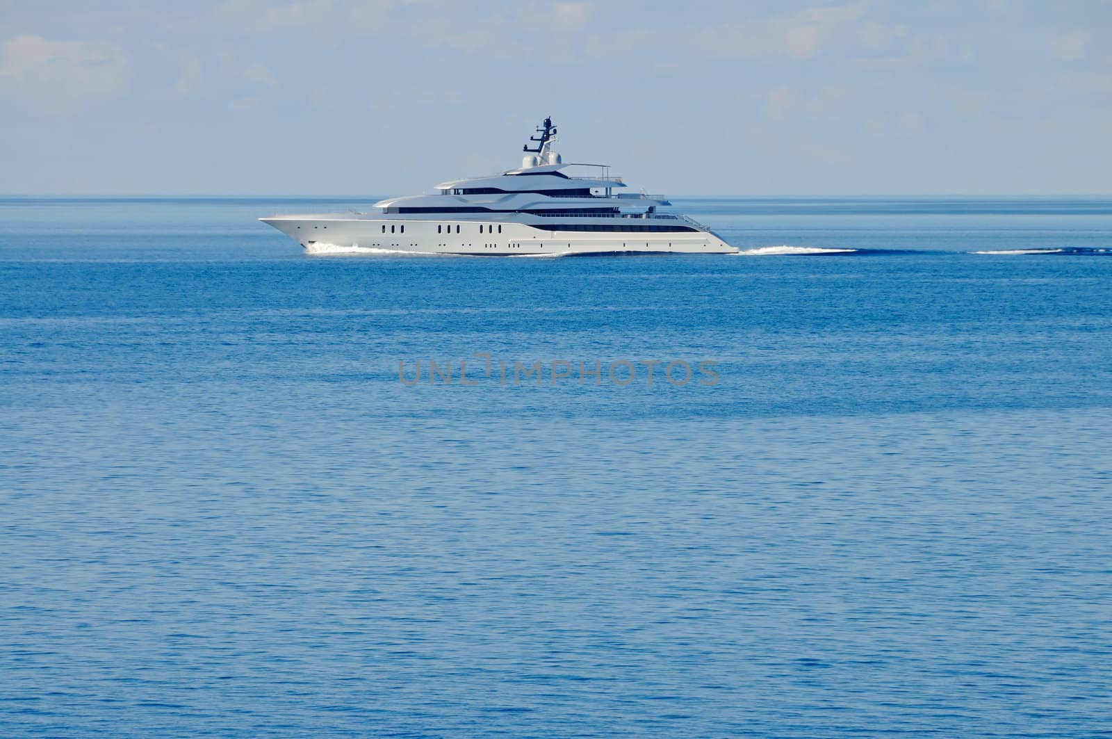 A large private motor yacht under way out at sea, copy space