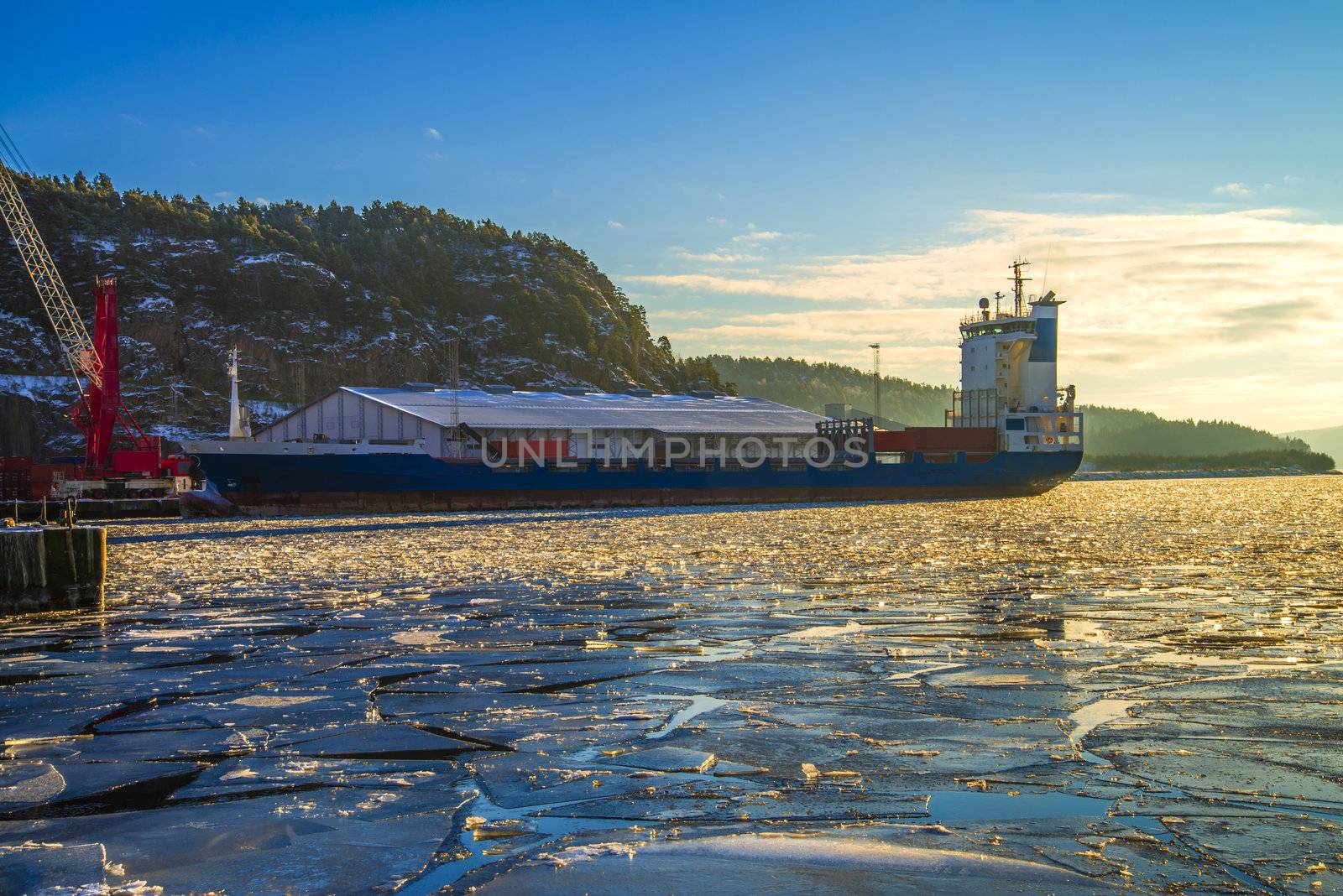 mv elisabeth is a container ship which has been docked at the port of Halden and unloaded containers and are about to leave the port of Halden, the image is shot in december 2012