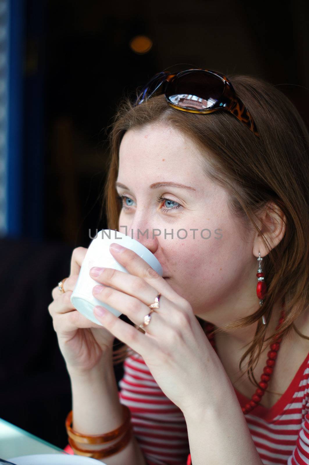 Nice blond woman drinking coffee by Elet