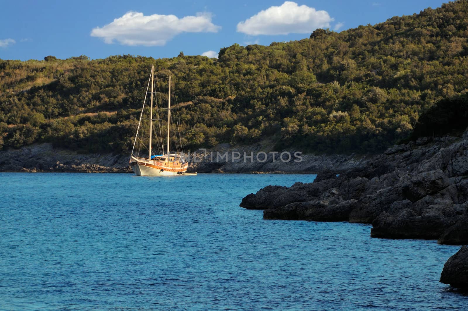 Sailing yacht anchored by the coast