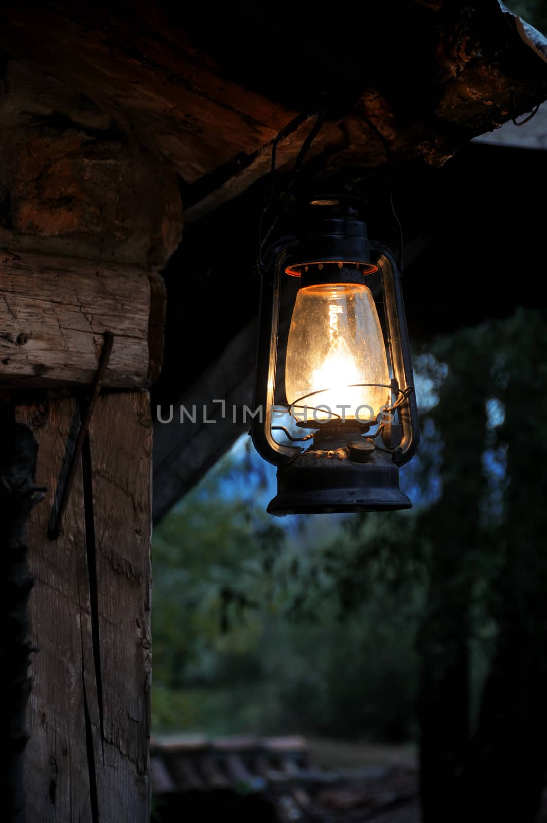 Lantern hang in front of wooden house in the night