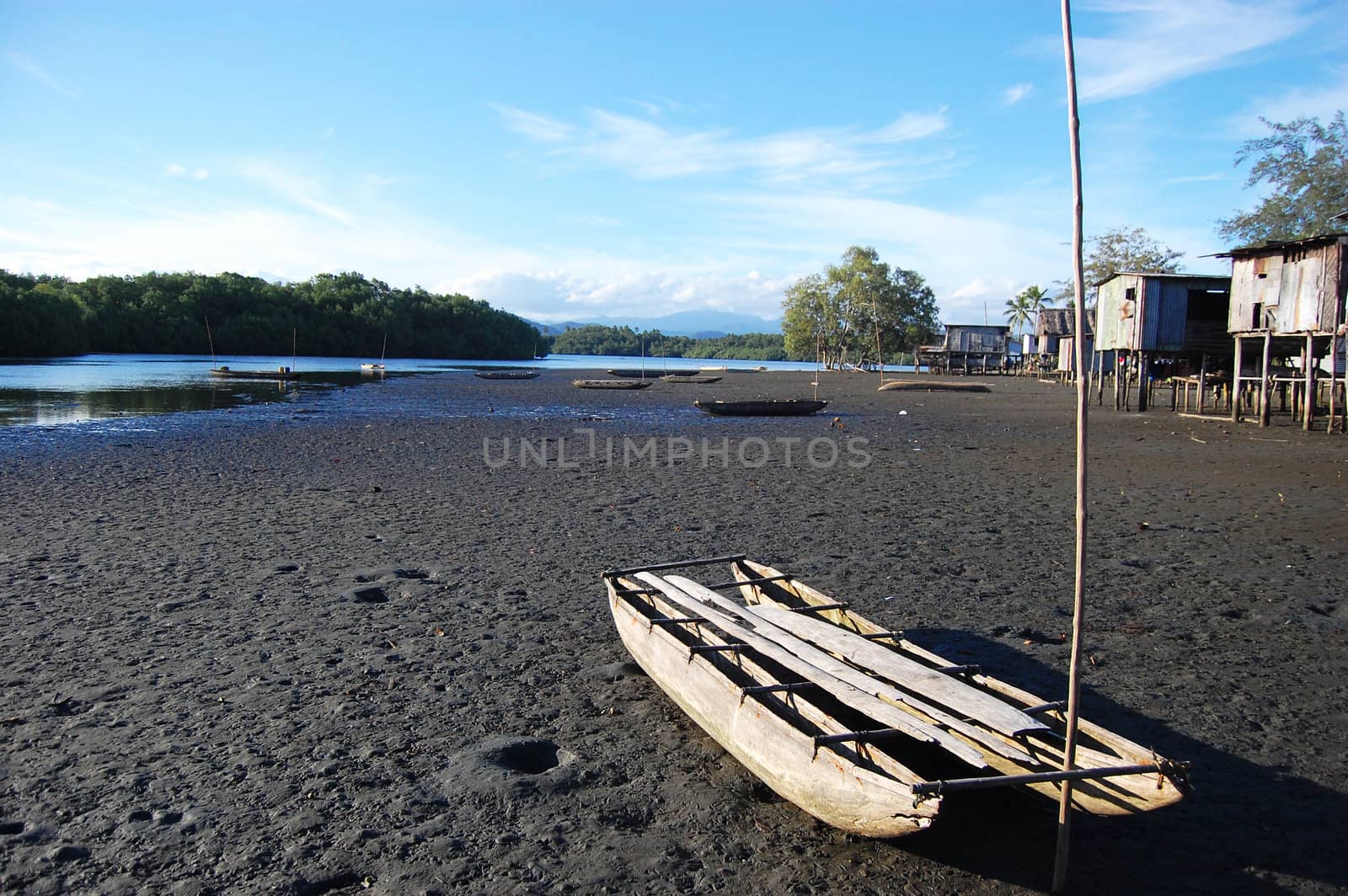 Canoe at village river coast by danemo