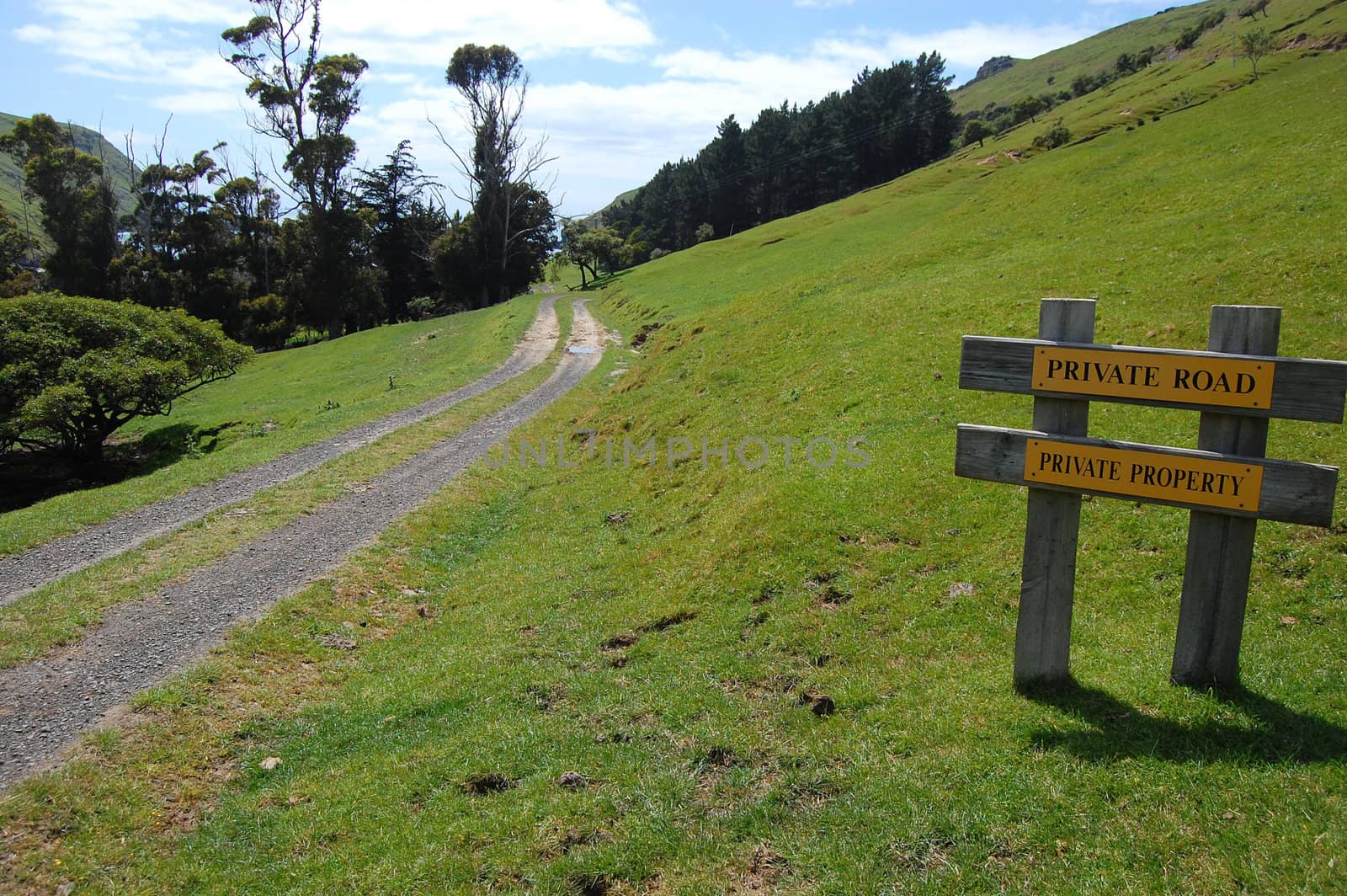 Gravel road rural area yellow sign, Banks Peninsula, New Zealand