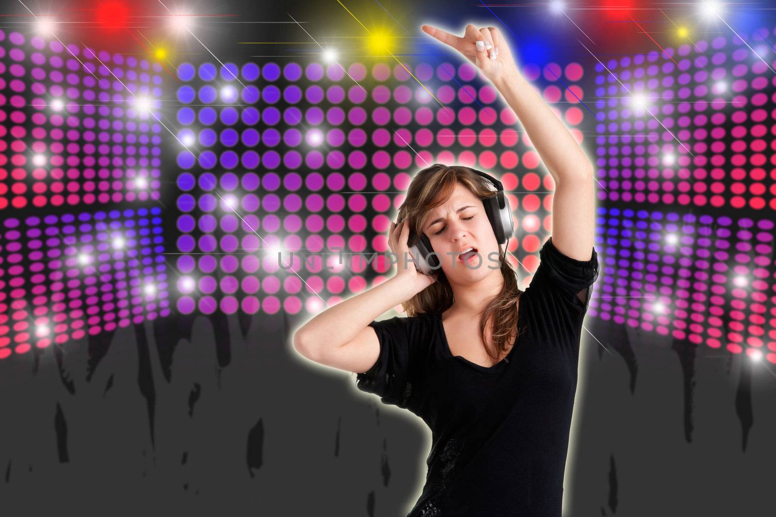 Woman dancing using headphones with disco lights in the background