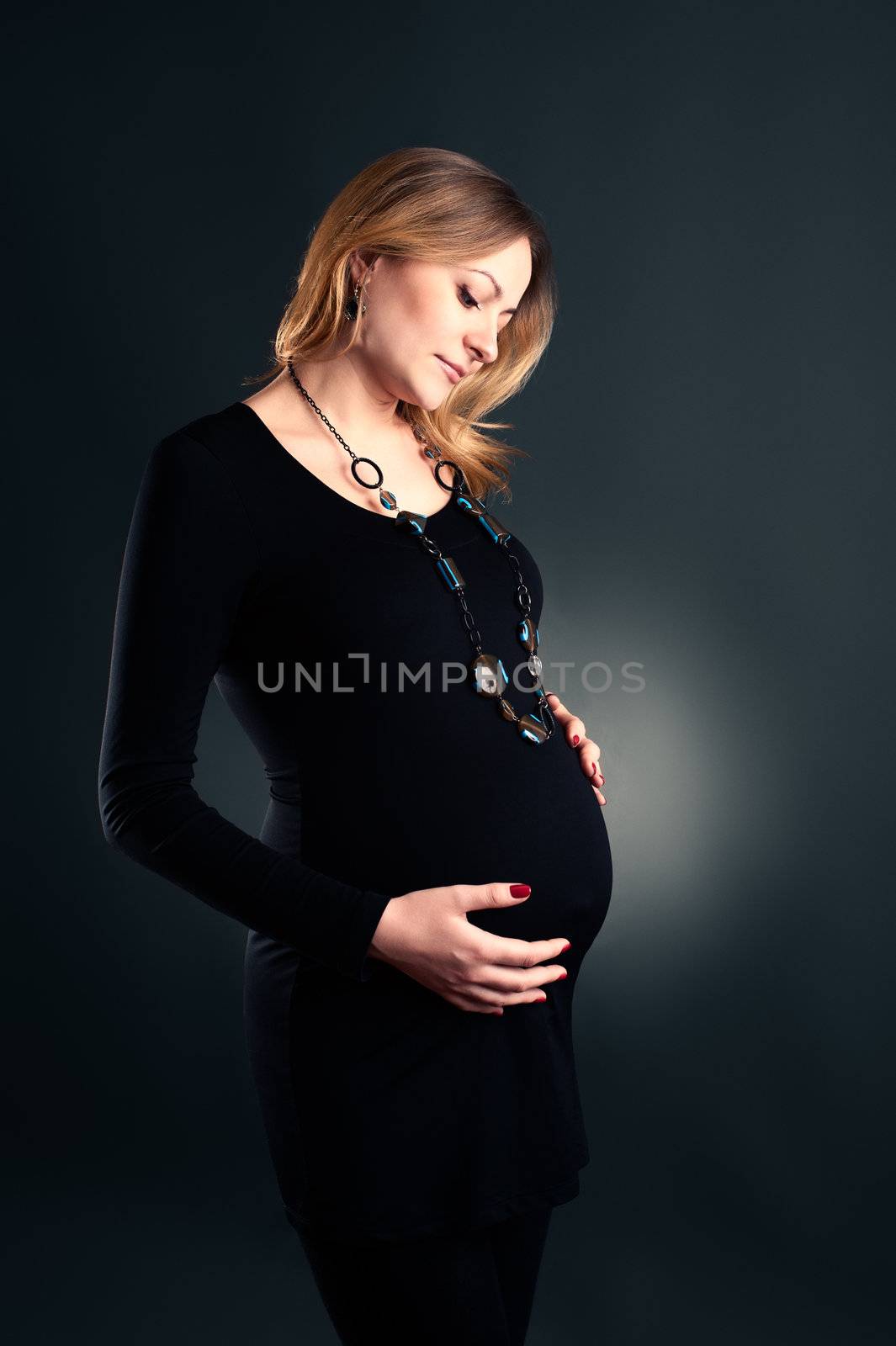 Studio shot of pregnant woman in little black dress