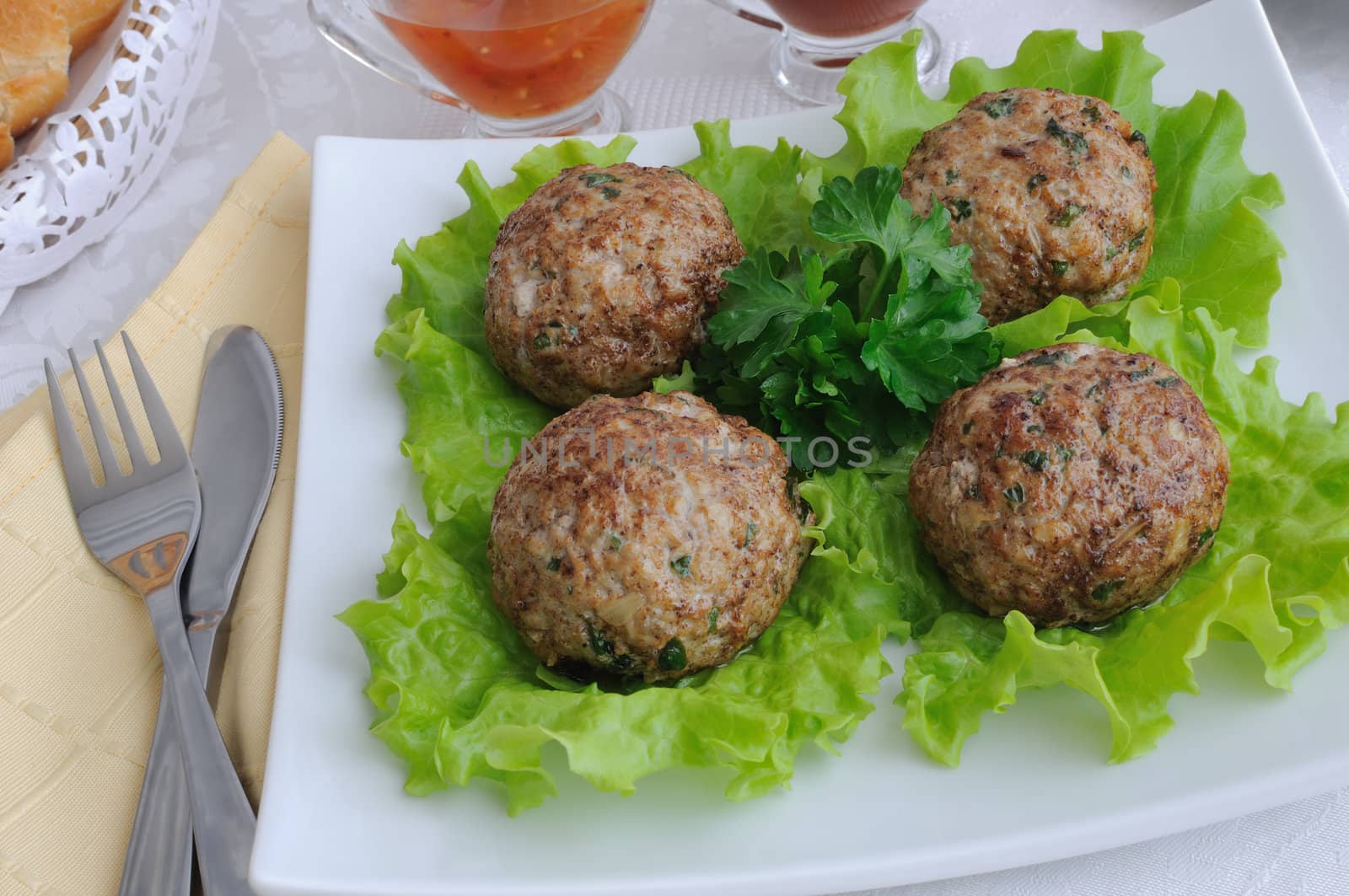  A meatball with greens on salad leaves 