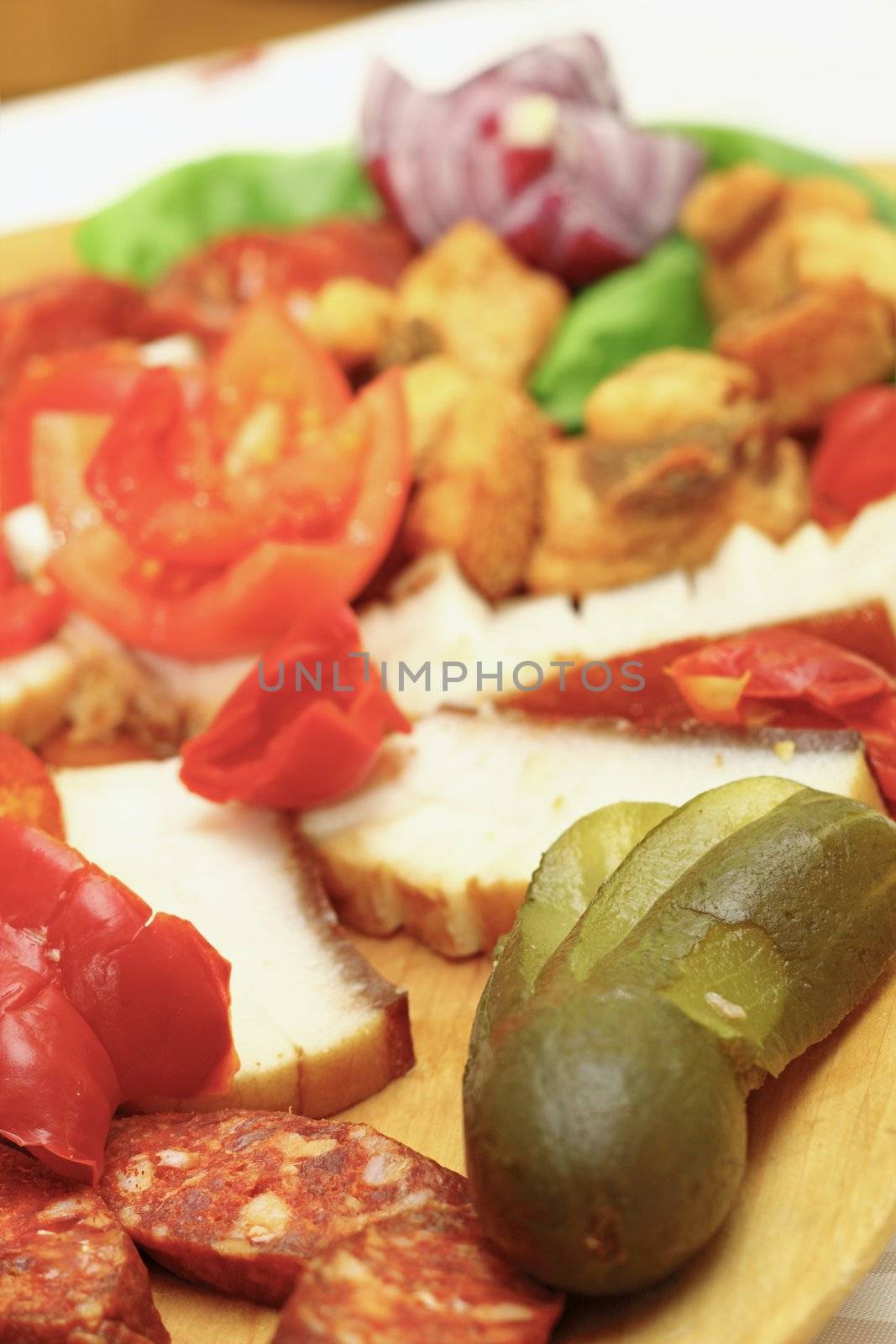 pickles and sausages served on a wooden traditional plateau