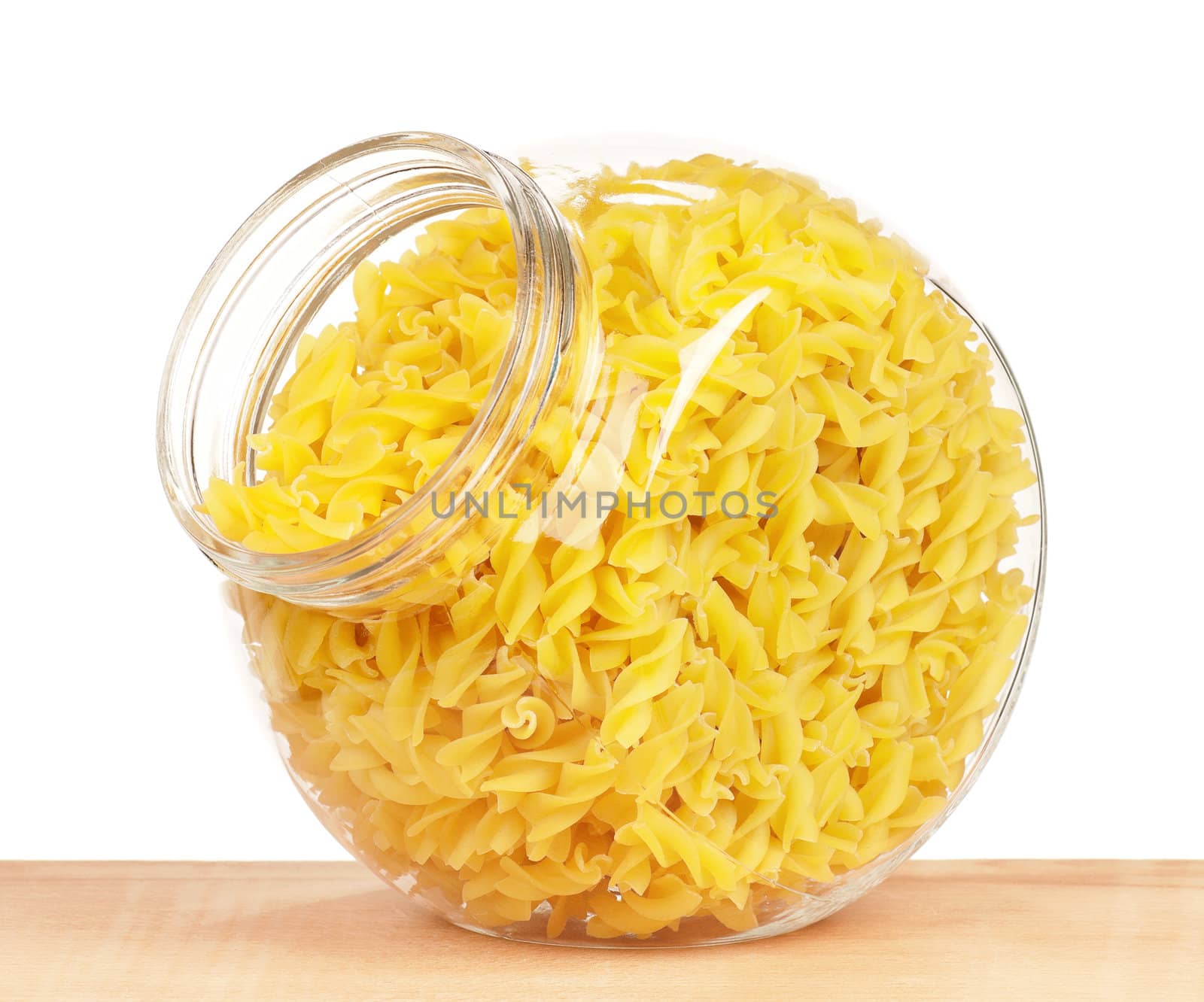 Pasta in glass pot isolated on white background