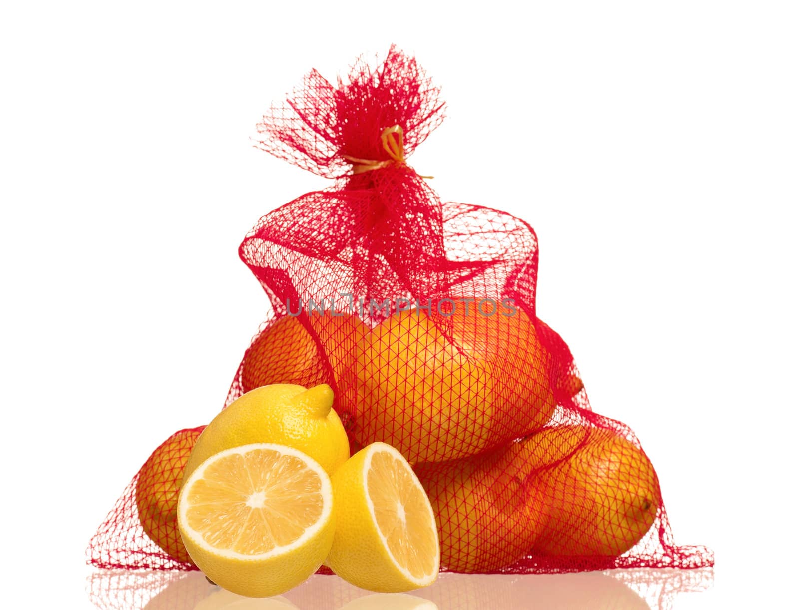 Lemons in net bag isolated on white background