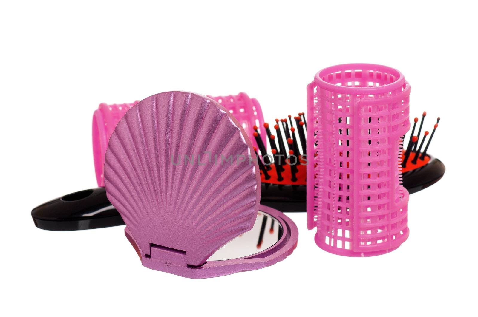 Set of cosmetics - hairbrush, hair curlers and small mirror isolated on white background