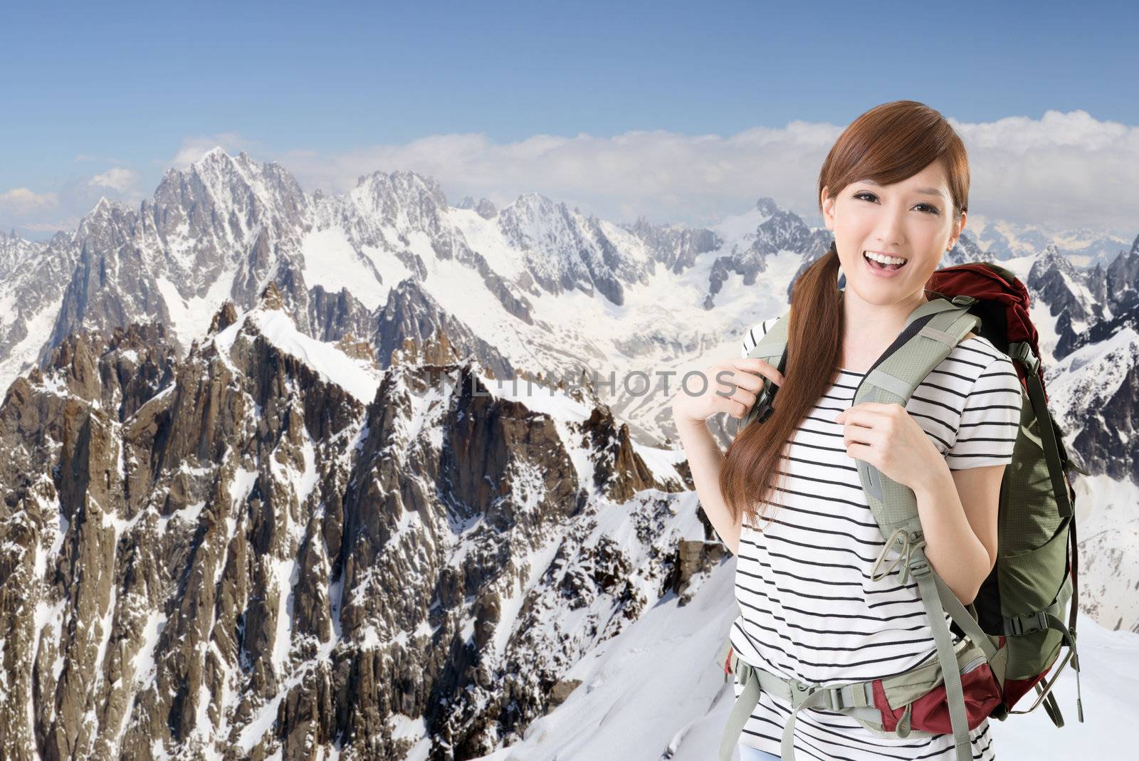 Happy smiling Asian woman travel and look at you at Chamonix in front of Mont Blanc, France.