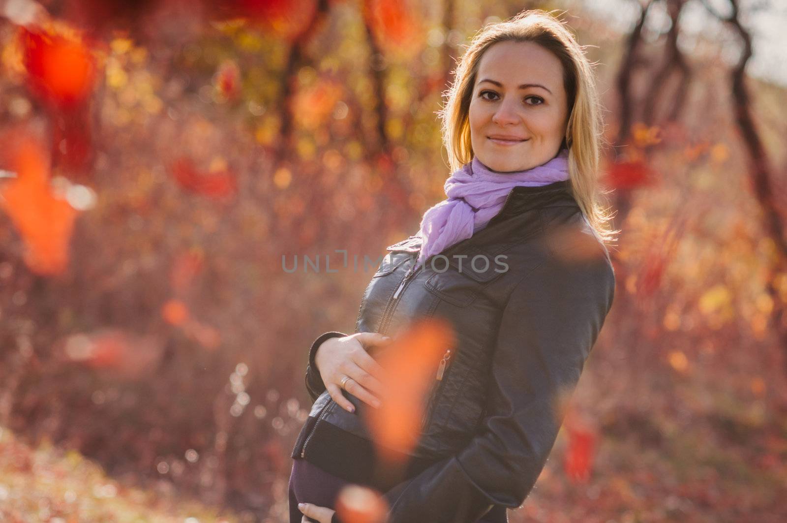 Pregnant woman in autumn forest by nvelichko