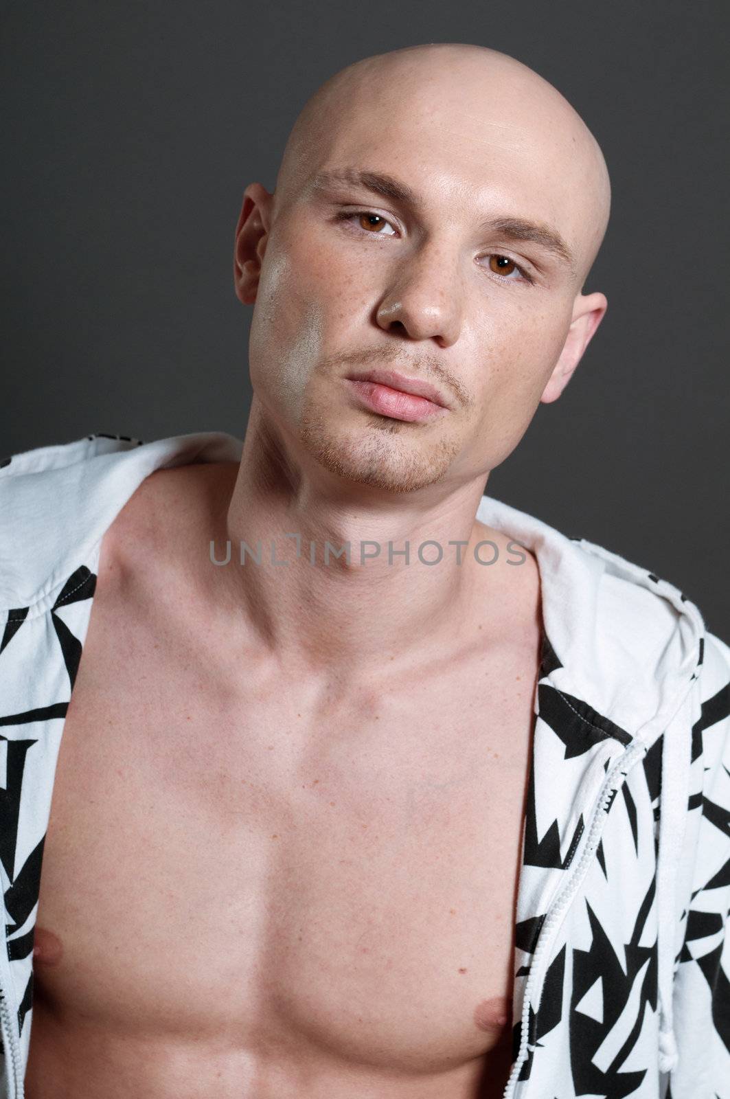 Studio portrait of shirtless muscled bald man