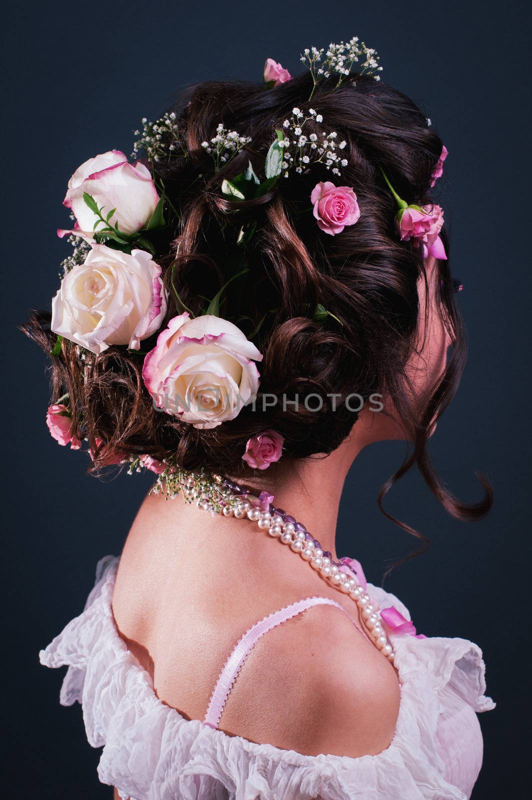 Young girl with creative hairstyle with flowers