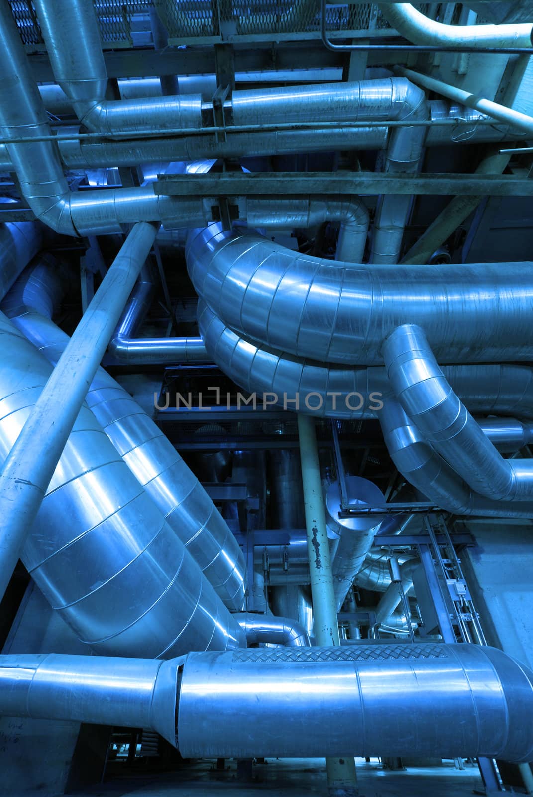 Industrial zone, installation of Steel pipelines and cables in blue tones