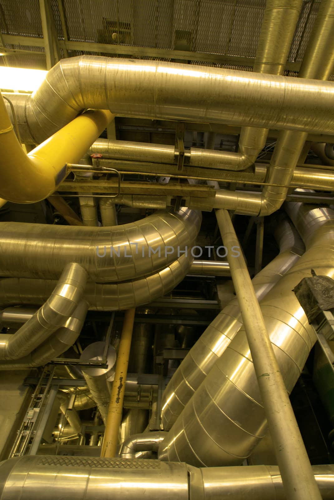 Industrial zone, Steel pipelines and cables in yellow tones