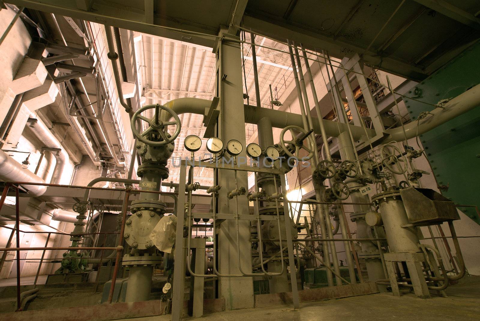 Equipment, cables and piping as found inside of  industrial power plant