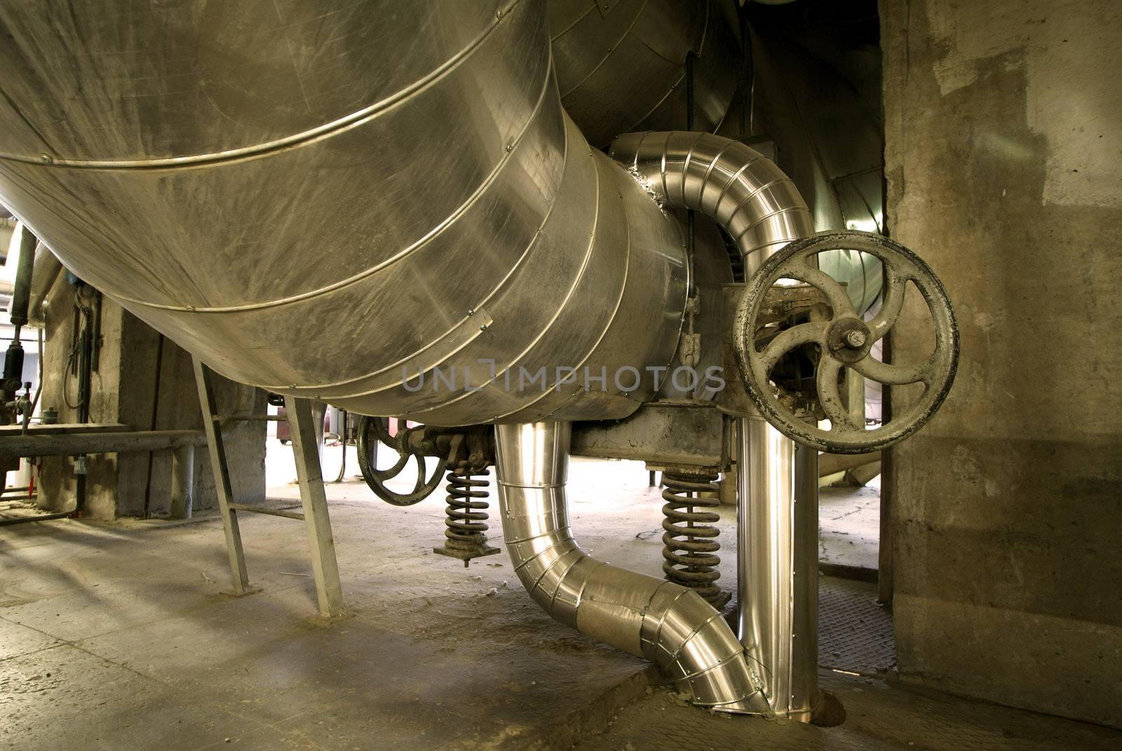 Equipment, cables and piping as found inside of  industrial power plant