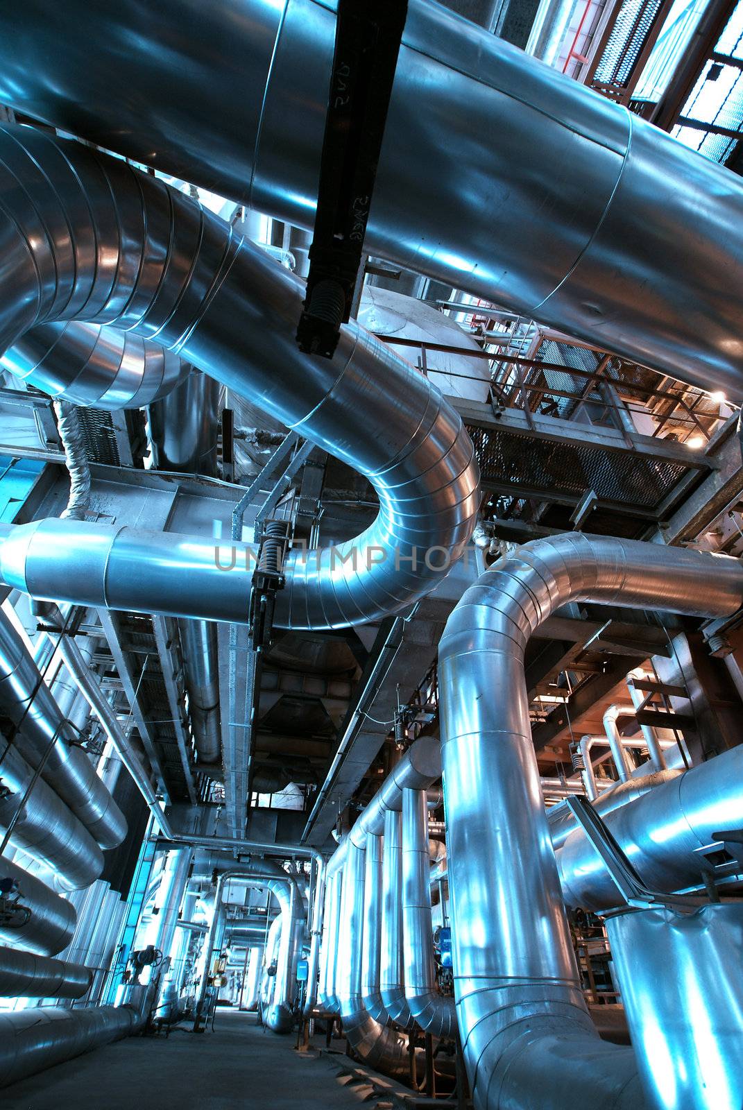 Equipment, cables and piping as found inside of  industrial power plant